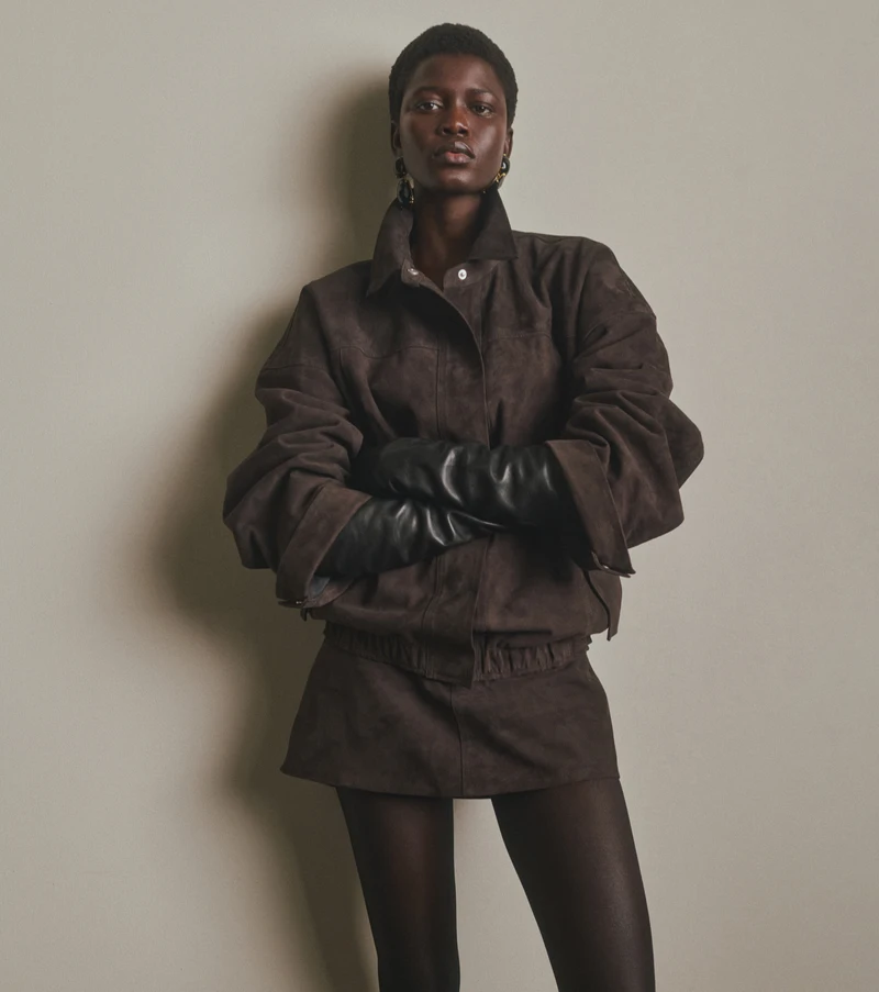 Close view of the brown jacket, shorts and black gloves