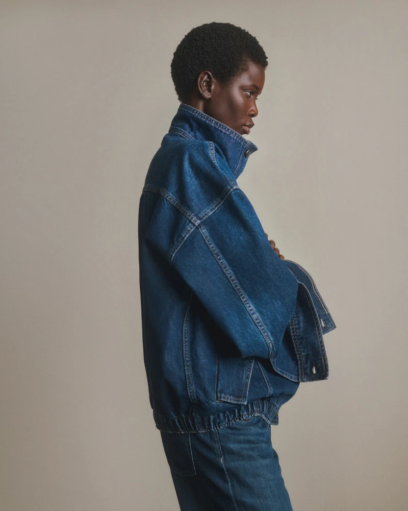 Profile view of a blue denim jacket