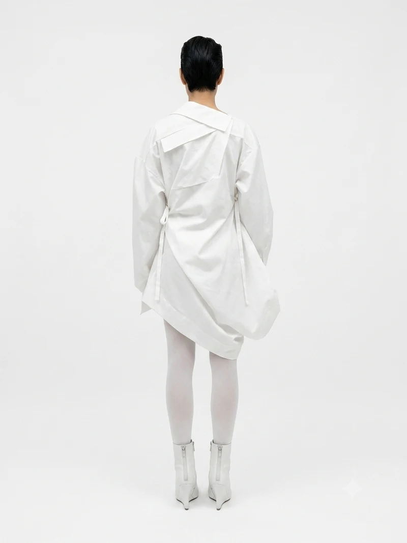 White sculptural shirt on a model — back view
