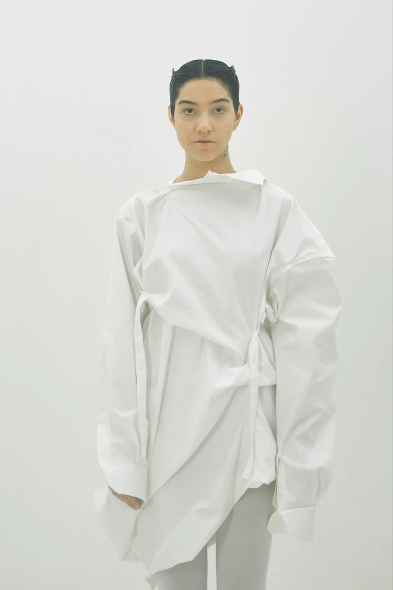 White sculptural shirt on a model — front view