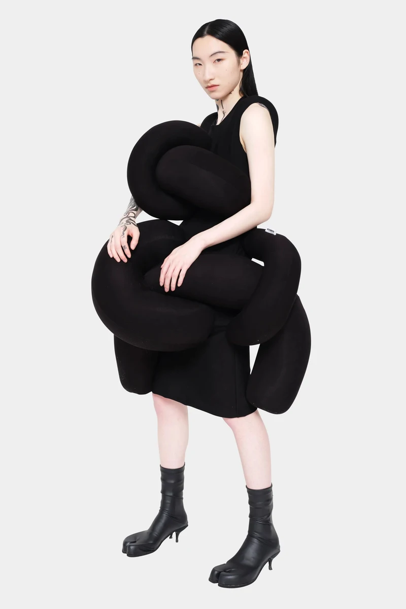 Black dress formed from sculptural padded coils
