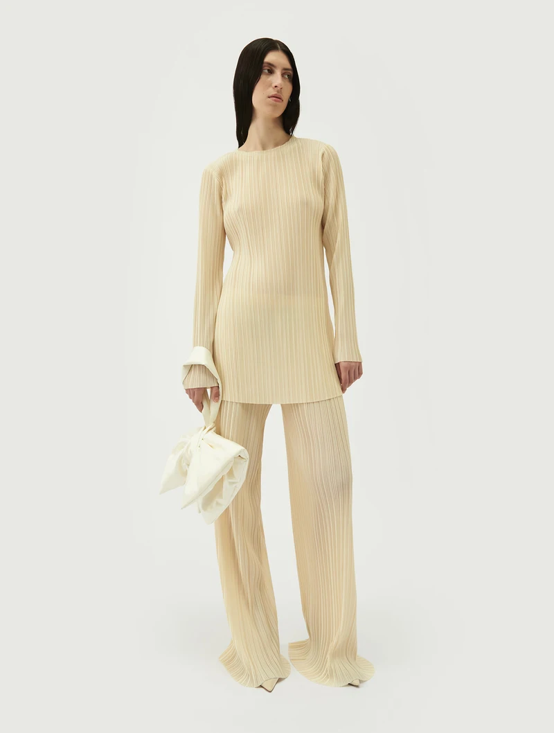 Ivory bow bag carried with cream separates