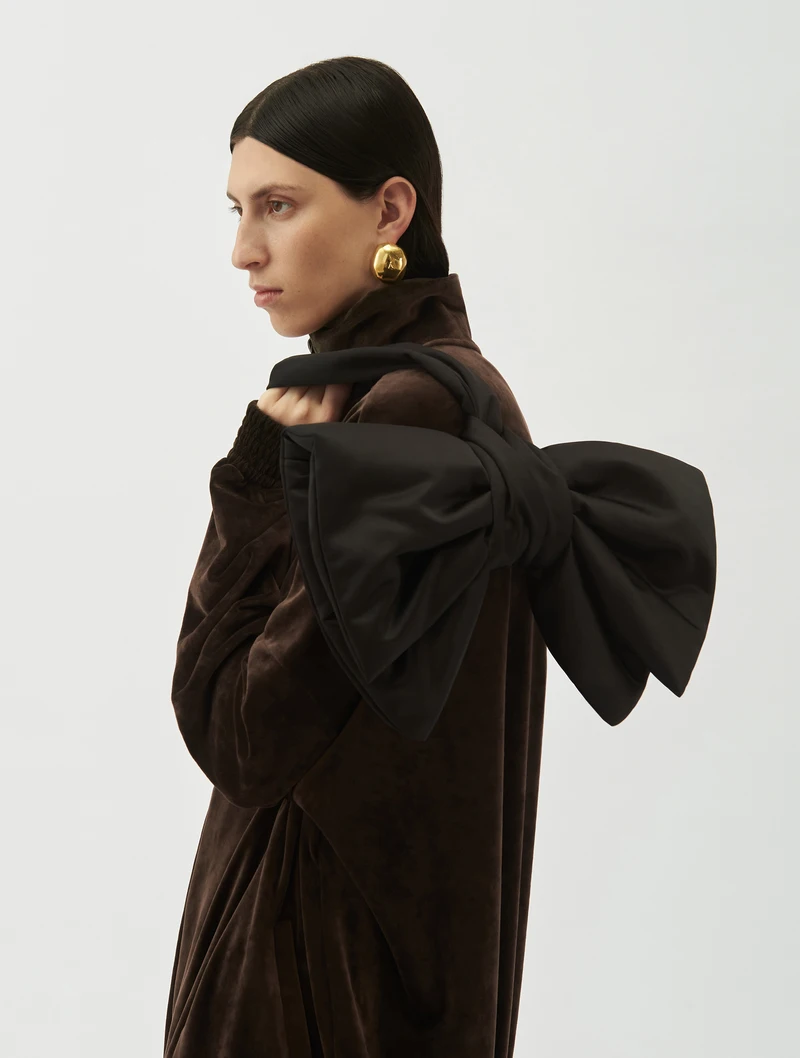 Black bow bag worn over the shoulder