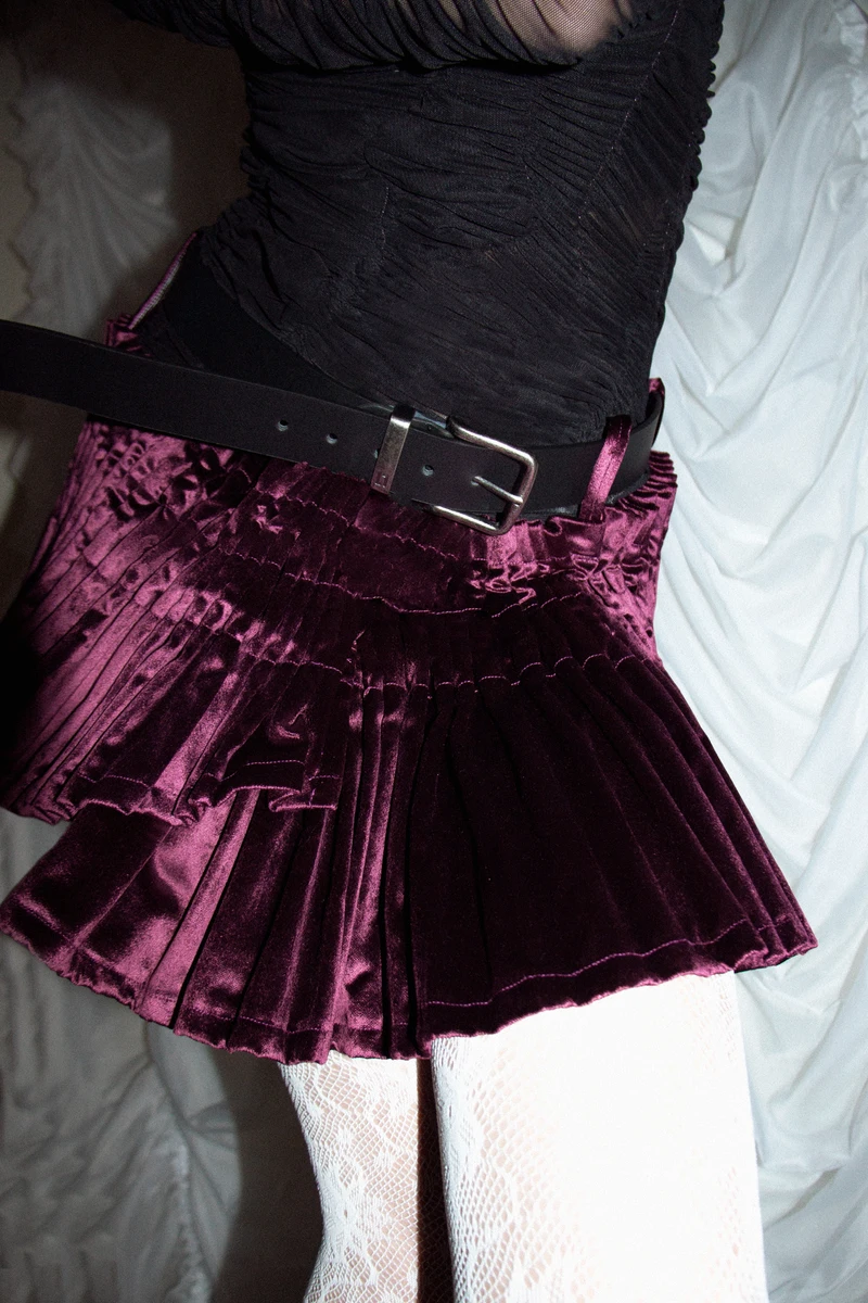 Detail of the short purple gathered skirt