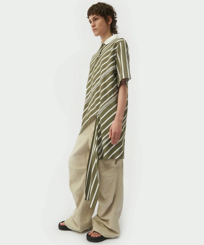 Striped spiral-cut shirt with cream trousers, side view